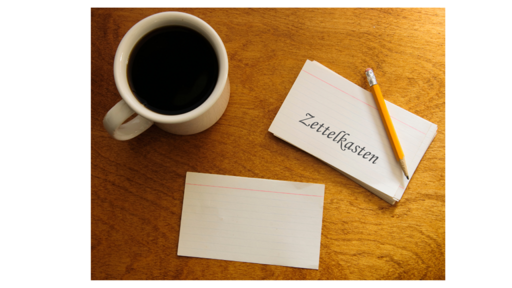 "Zettelkasten" on a card with coffee and a pencil