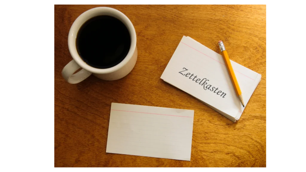 "Zettelkasten" on a card with coffee and a pencil